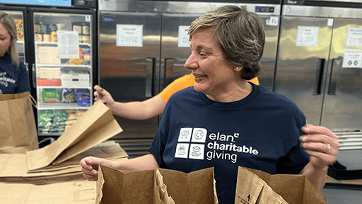 Elan employee packing food bags.